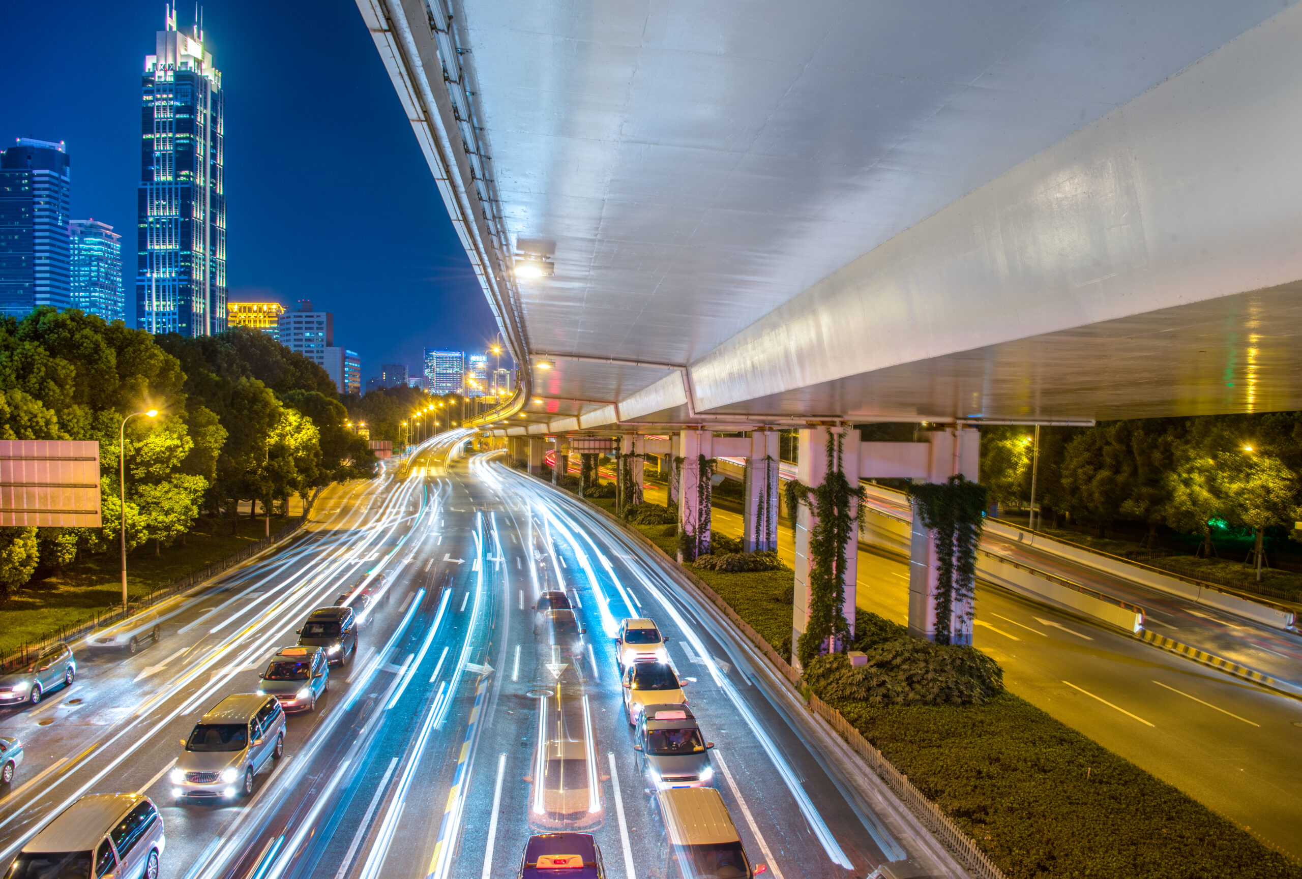 Smart Cities & Public Infrastructure 2 city view night with traffic trail light (1)