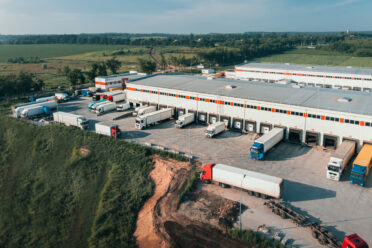 Home Page 27 trucks with trailers are loaded unloaded cargo terminal morning aerial shot contai